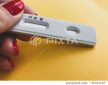 medical procedures. coronavirus test on a bright yellow background. new home self-diagnosis kit. window for antibodies. girl with bright red manicure going to have a blood test 76303297
