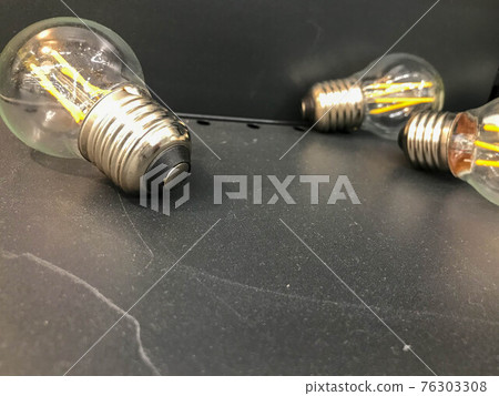 glass lamp, electrician for the apartment. incandescent light bulb for light in the house. bright chandeliers, glass bulbs with a light element inside glass lamp, electrician for the apartment. incandescent light bulb for light in the house. bright chandeliers, glass bulbs with a light element inside 76303308