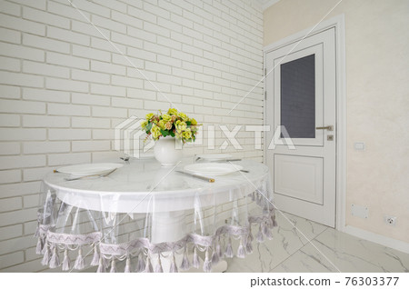 Elegant white round dining table in modern kitchen interior 76303377
