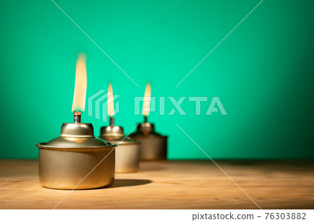 Pelita or oil lamp, traditional Malay oil lamp lit up during Ramadan and Hari Raya Aidilfitri Muslim celebration Pelita or oil lamp, traditional Malay oil lamp lit up during Ramadan and Hari Raya Aidilfitri Muslim celebration 76303882