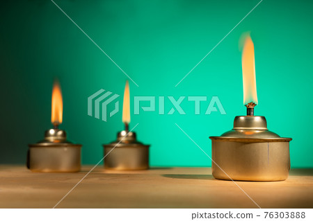 Pelita or oil lamp, traditional Malay oil lamp lit up during Ramadan and Hari Raya Aidilfitri Muslim celebration Pelita or oil lamp, traditional Malay oil lamp lit up during Ramadan and Hari Raya Aidilfitri Muslim celebration 76303888