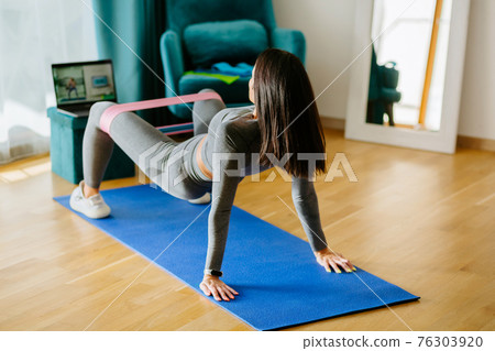 Fit young Pacific Islander woman fitness training at home Fit young Pacific Islander woman fitness training at home 76303920