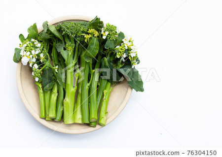 Green baby broccoli with chinese kale floweron white background. Green baby broccoli with chinese kale floweron white background. 76304150