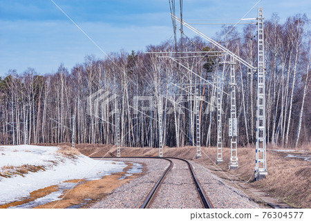 Electrified railway line at winter day, 76304577