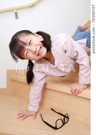 Toddler girl falling down the stairs at home Toddler girl falling down the stairs at home 76306587