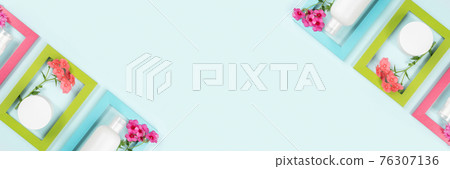 Cosmetics for skin care face, body, hands. White blank cosmetic bottle, tube, jar, flowers in bright frames on blue background. Creative Cosmetic Beauty Concept. Mockup Top view Banner 76307136