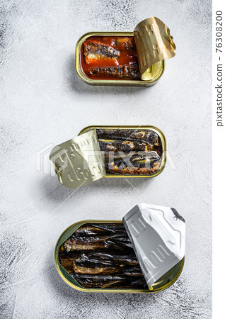 Assorted canned fish in a tin sardine, smoked sardine, mackerel. Grey wooden background. Top view Assorted canned fish in a tin sardine, smoked sardine, mackerel. Grey wooden background. Top view 76308200