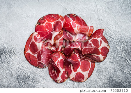 Coppa Cured ham on kitchen table. White background. Top view Coppa Cured ham on kitchen table. White background. Top view 76308510