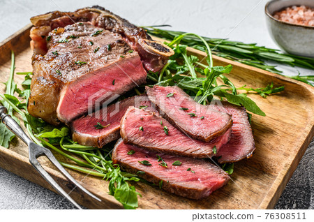 Sliced grilled club beef meat steak or new york steak. White background. Top view 76308511