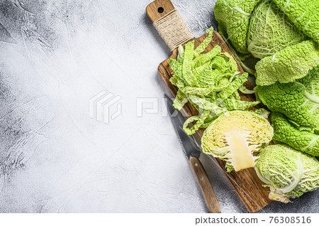 Sliced Savoy cabbage from organic grower farm. White background. Top view. Copy space Sliced Savoy cabbage from organic grower farm. White background. Top view. Copy space 76308516