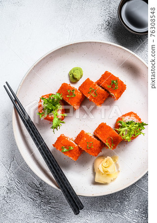 Sushi Maki roll with avocado and shrimp meat. Gray background. Top view Sushi Maki roll with avocado and shrimp meat. Gray background. Top view 76308548