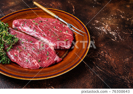 Raw rump cap steak or top sirloin steak in rustic plate with thyme and olive oil. Dark background. Top view. Copy space Raw rump cap steak or top sirloin steak in rustic plate with thyme and olive oil. Dark background. Top view. Copy space 76308643