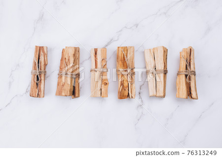Palo Santo tree sticks on marble background - holy incense tree from Latin America. Meditation, mental health and personal fulfilment concept. Selective focus Palo Santo tree sticks on marble background - holy incense tree from Latin America. Meditation, mental health and personal fulfilment concept. Selective focus 76313249