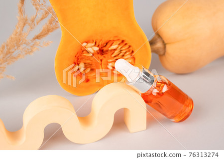 Still life composition, dropper bottle of modern organic cosmetics - natural pumpkin seeds oil extract for skincare or hair with pumpkins and plaster figures. Beauty treatment and spa concept Still life composition, dropper bottle of modern organic cosmetics - natural pumpkin seeds oil extract for skincare or hair with pumpkins and plaster figures. Beauty treatment and spa concept 76313274