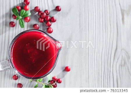 Homemade fresh wild lingonberry sauce in a glass gravy boat, top view, flat lay, copyspace Homemade fresh wild lingonberry sauce in a glass gravy boat, top view, flat lay, copyspace 76313345