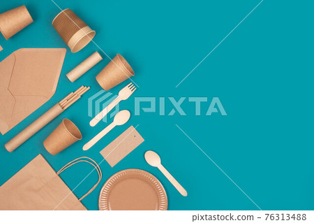 Flat lay composition, set of eco-friendly tableware and kraft paper food packaging on green background with copy space. Street food paper packaging - cups, plates, straws, containers and paper bags Flat lay composition, set of eco-friendly tableware and kraft paper food packaging on green background with copy space. Street food paper packaging - cups, plates, straws, containers and paper bags 76313488