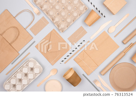 Flat lay composition with eco-friendly tableware and kraft paper food packaging on gray background. Sustainable packaging, recyclable paperware, zero waste packaging concept. Mockup, selective focus Flat lay composition with eco-friendly tableware and kraft paper food packaging on gray background. Sustainable packaging, recyclable paperware, zero waste packaging concept. Mockup, selective focus 76313524