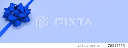 Banner with decorative blue ribbon bow on blue background with copy space for text. Giving presents concept. Greeting card or holidays sale background. Selective focus Banner with decorative blue ribbon bow on blue background with copy space for text. Giving presents concept. Greeting card or holidays sale background. Selective focus 76313553