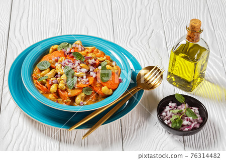 carrot curry with cashew and raisins, top view carrot curry with cashew and raisins, top view 76314482