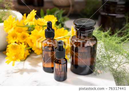 Herbal oil, essential oil, perfume on apothecary glass bottles 76317441