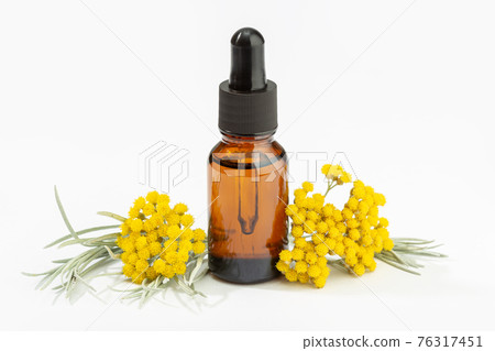 Helichrysum essential oil on amber bottle isolated on white background Helichrysum essential oil on amber bottle isolated on white background 76317451