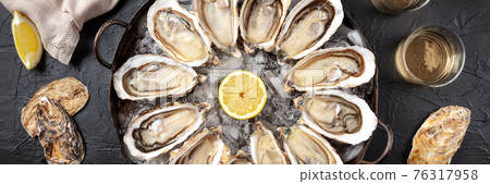 Oysters panorama. A platter of raw oysters, overhead flat lay shot 76317958