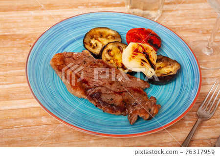 Appetizing beef entrecote with baked vegetables Appetizing beef entrecote with baked vegetables 76317959
