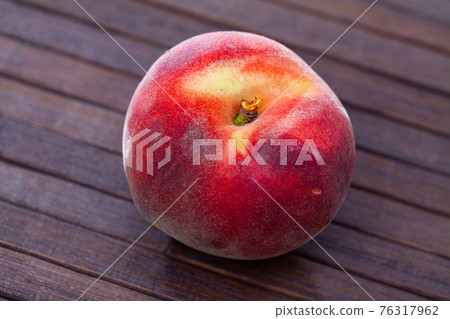 Closeup of whole ripe red peaches on wooden table. Closeup of whole ripe red peaches on wooden table. 76317962