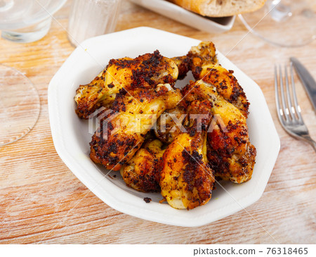 fried hot chicken wings on white plate for brunch fried hot chicken wings on white plate for brunch 76318465
