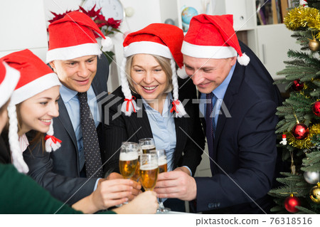 Happy business group people in santa hat at Xmas corporate party 76318516