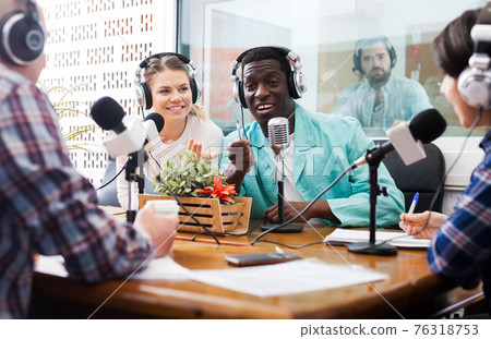 Radio hosts interviewing guest 76318753