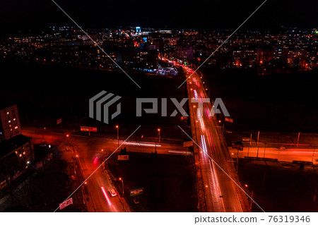 Night streets, highway and car traffic in the city of Ivano-Frankivsk, lights from car traffic, top view of the street. 76319346
