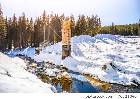 Broken dam in winter mountains Broken dam in winter mountains 76321066