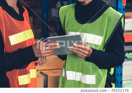 Female warehouse worker working at the storehouse 76322176