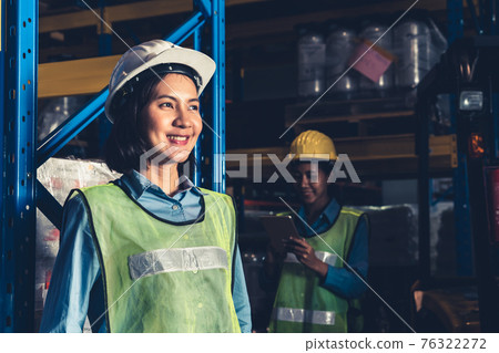 Portrait of young Asian woman warehouse worker smiling in the storehouse Portrait of young Asian woman warehouse worker smiling in the storehouse 76322272