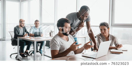 Website header of Three business colleagues discussing projects in modern office interior Website header of Three business colleagues discussing projects in modern office interior 76323023