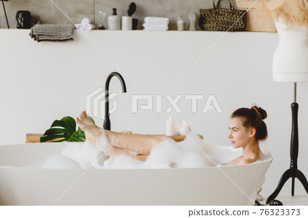 Beautiful woman in a bubble bath. 76323373