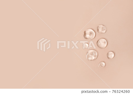 Lotion transparent gel drops texture background, Close-up drops transparent cosmetic aloe vera gel on neutral beige background with copy space. Body care and skin care, moistirize 76324260