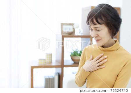 Senior woman putting her hand on her chest Senior woman putting her hand on her chest 76324740
