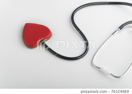 Stethoscope and red heart. Follow your heart. White background Stethoscope and red heart. Follow your heart. White background 76324869