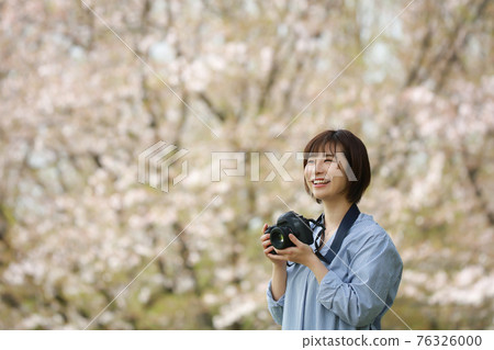A woman taking a picture A woman taking a picture 76326000