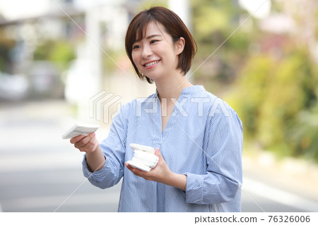 Woman giving out tissue Woman giving out tissue 76326006