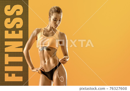 young fitness woman on yellow background young fitness woman on yellow background 76327608