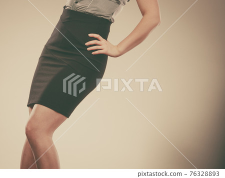 Woman wearing elegant tight dark black skirt Woman wearing elegant tight dark black skirt 76328893