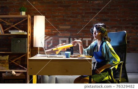 Young Caucasian woman during online cooking lesson through laptop. 76329482