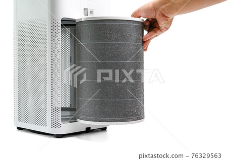 Man hold a old Filter of  the air purifier check with change filter in side air purifier for dust removal efficiency on white background 76329563