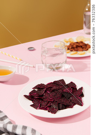 Dried fruits, drink and nuts with sauce on pink table Dried fruits, drink and nuts with sauce on pink table 76332386