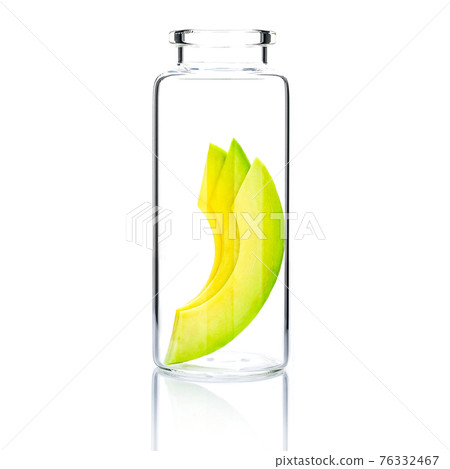 Homemade skin care with  avocado slice in a glass bottle isolated on white background. 76332467