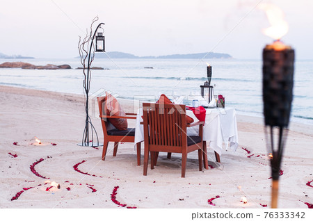Honeymoon dinner table on island beach in Thailand Honeymoon dinner table on island beach in Thailand 76333342