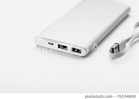 Powerbank for charging mobile devices with cable, on a white background. 76334608